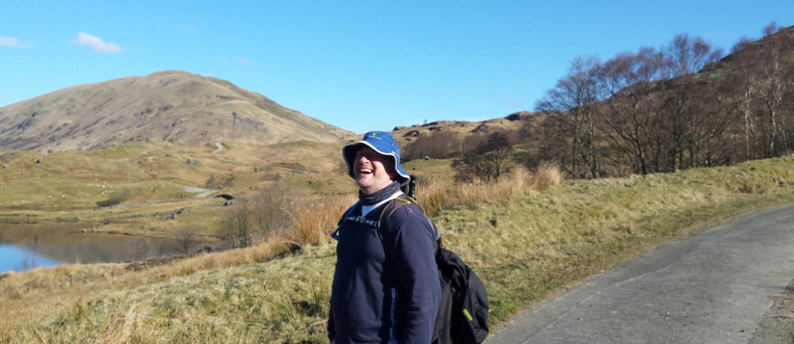 Man laughing whilst on trail.